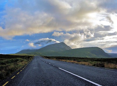 road with mountains in the background