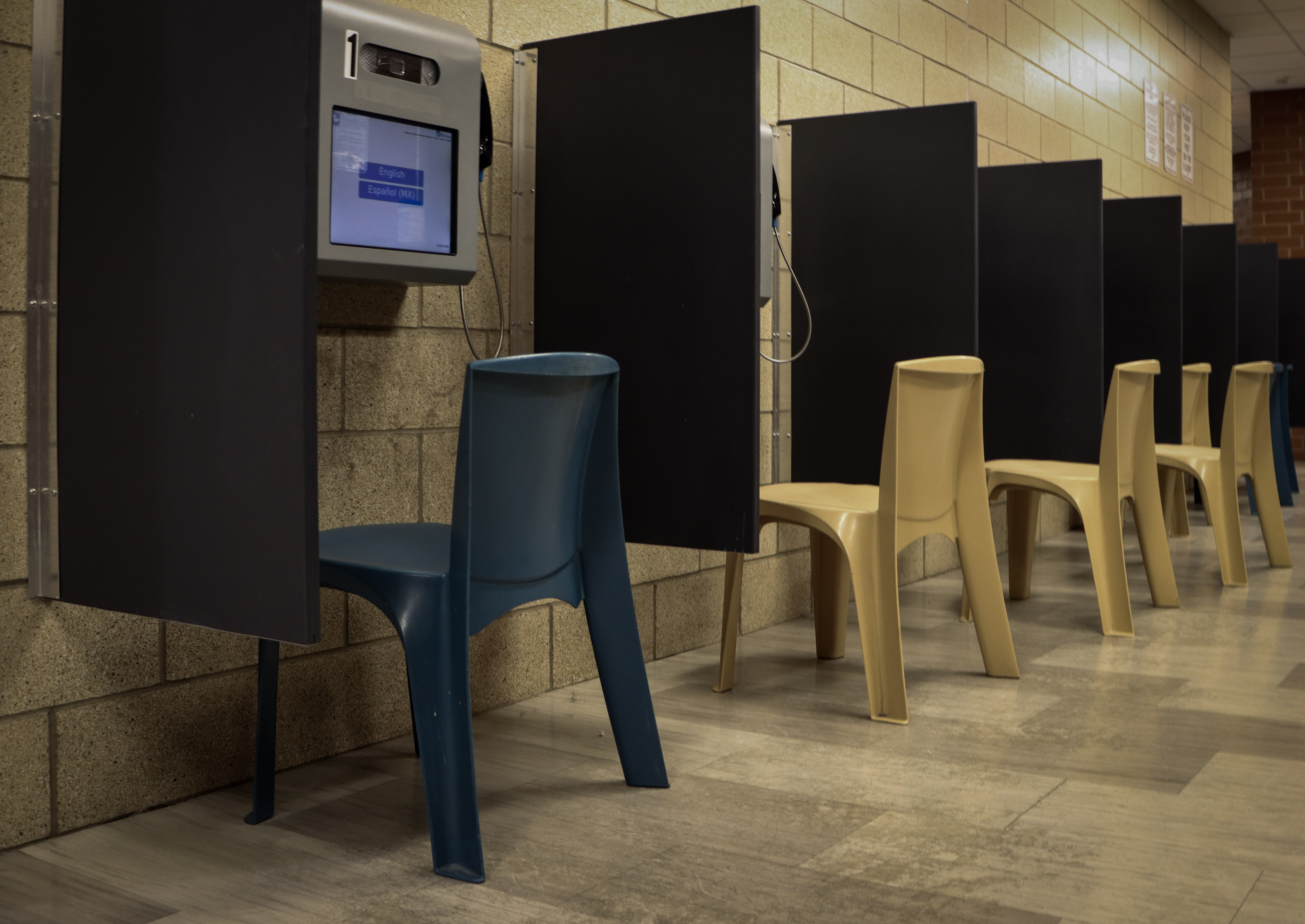 Chairs lined up at each calling station for friends and family to talk with inmates in jail.